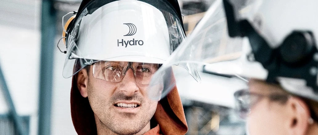 Hydro industrial workers wearing protective helmets and face shields